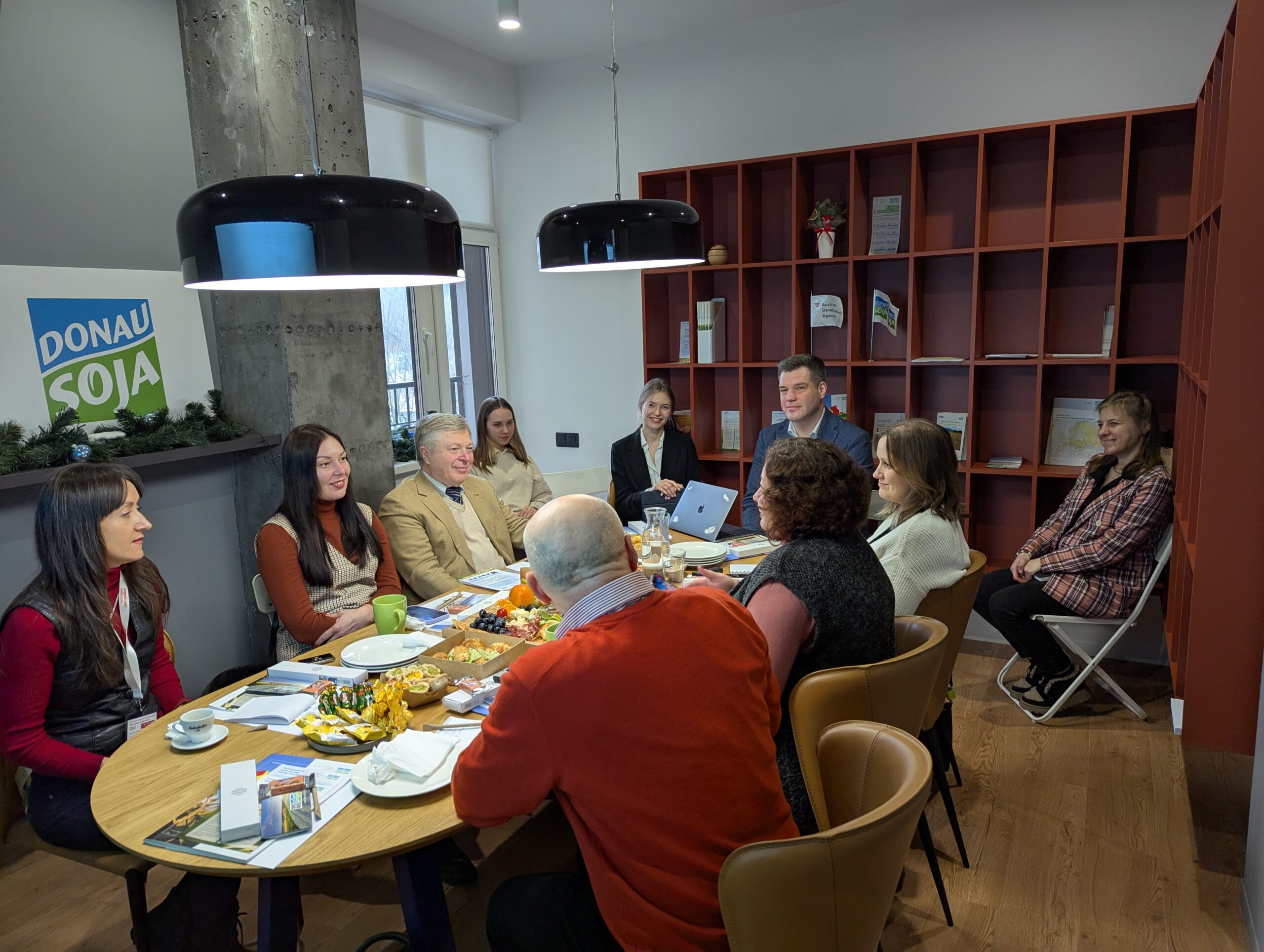 Group of Ukrainian agricultural media representatives at Donau Soja’s media lunch in Kyiv, discussing sustainability and soybean market trends.